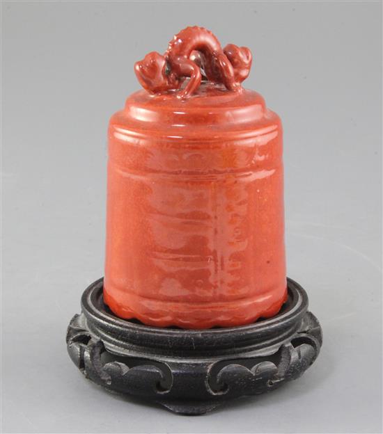 A Chinese coral red glazed model of a temple bell, Republic period, height 11cm, wood stand